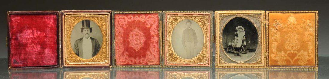 Lot of 3: Daguerreotypes.: Lot includes: one ambrotype of a young girl with a horse pull toy that has minor flaking; a tin type of a young man, case separate; and a tin type of a man in a tall hat, case separate. Condition (Exc