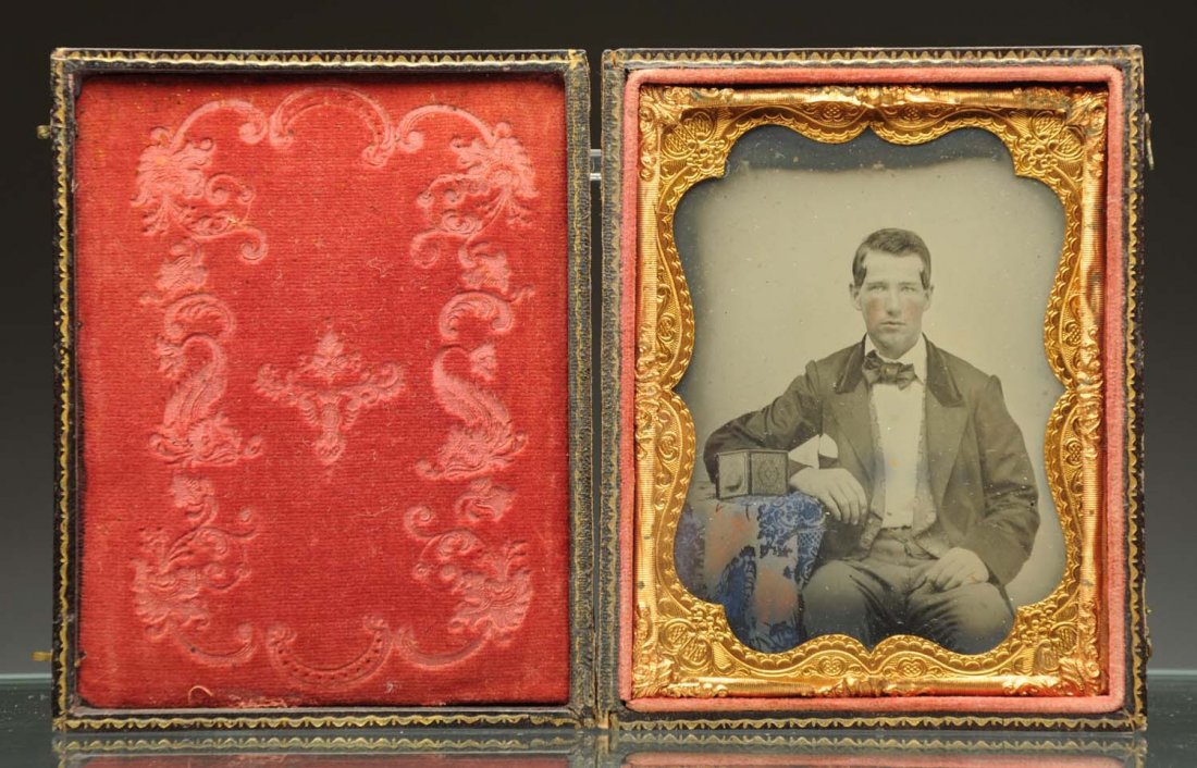 Daguerreotype Portrait.: 1/4 plate ambrotype of a man sitting besides a daguerreotype on a table. Clear image. Leather case separated. Condition (Excellent). Size Largest: 4 - 1/2" L.