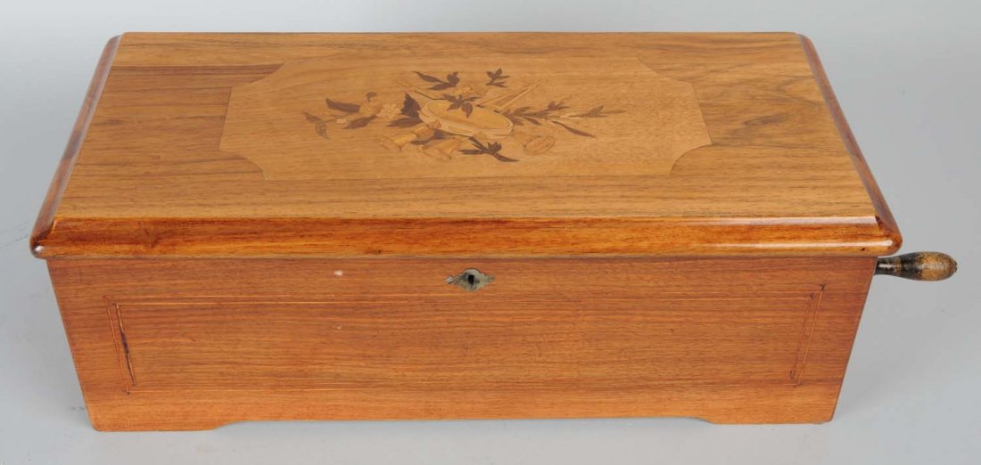 Mermod Freres 10 Tune Coin-Op Cylinder Music Box.: Penny operated. SN-57296. Box retains original tune sheet. The single 7 - 5/8” cylinder plays on 41 tooth comb that is housed in the original fruitwood case with a marquetry inlaid lid. The mechanis