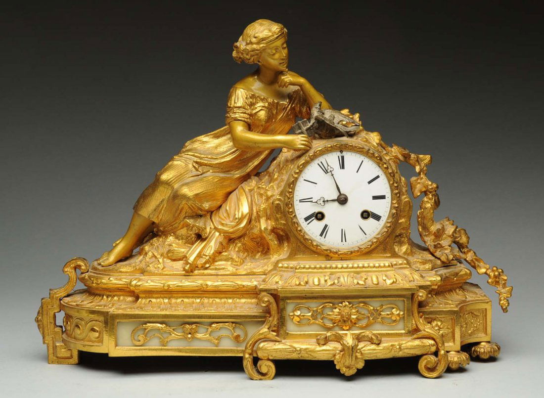 Dore Bronze Figurative 8 Day Clock.: Has key and pendulum. Condition (Excellent). Size 11 - 1/2" T.