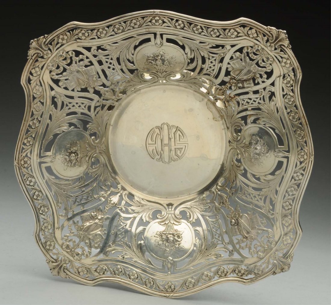 American Sterling Center Bowl.: Graff Washbourne & Dunn retailed by Grogan & Co, Chicago, with a shaped square molded rim around pierced sides with four panels chased with flower vases. Size: 11 x 11 in Weight: 17.5 ozt Notes: - - m