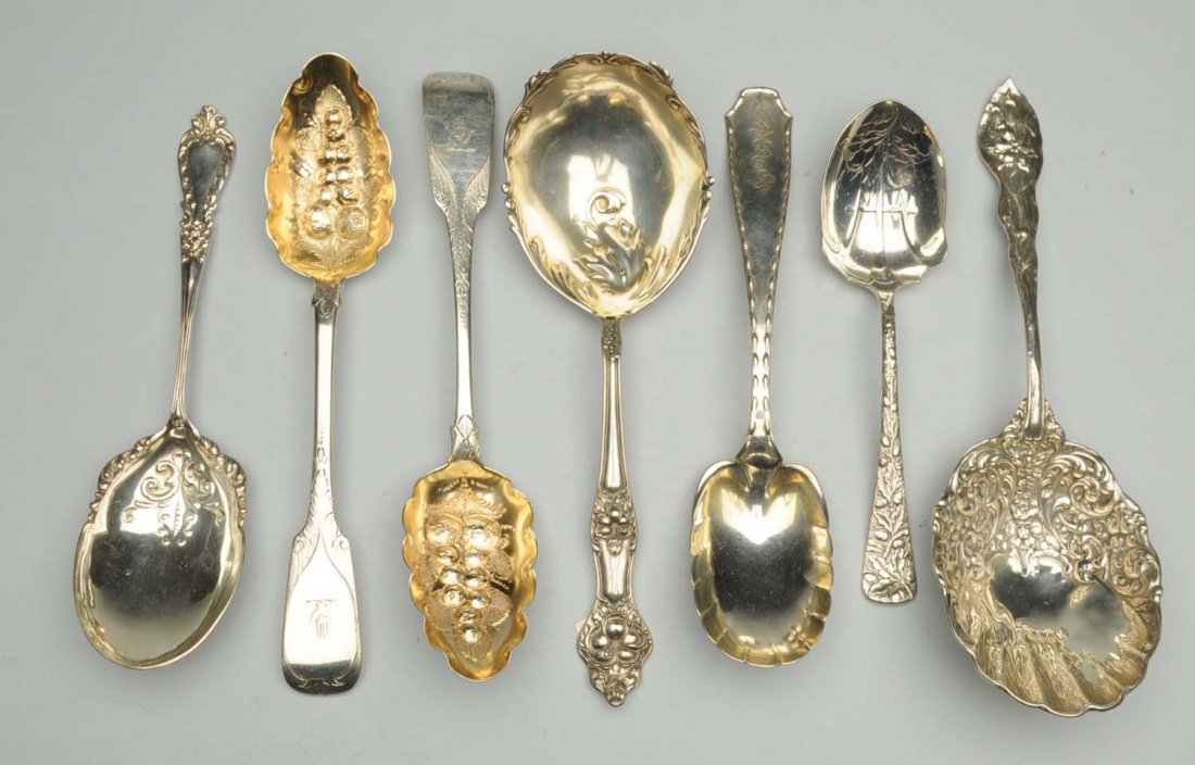 Group of Sterling Serving Spoons.: Including two Fiddle pattern berry spoons, one London the other Dublin, both with gilt bowls chased with fruit and decorated stems, the handles crested; a Tiffany Marquise pattern preserve spoon with 