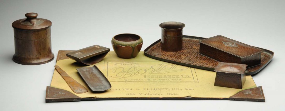 Roycroft Arts & Crafts Hammered Copper Desk Set.: Four corners for pad, pencil holder, letter opener, inkwell blotter, pencil cup holder, decorated bowl, tobacco humidor, lidded box and tray. All incised with Roycroft mark. Condition (Excellent). Siz