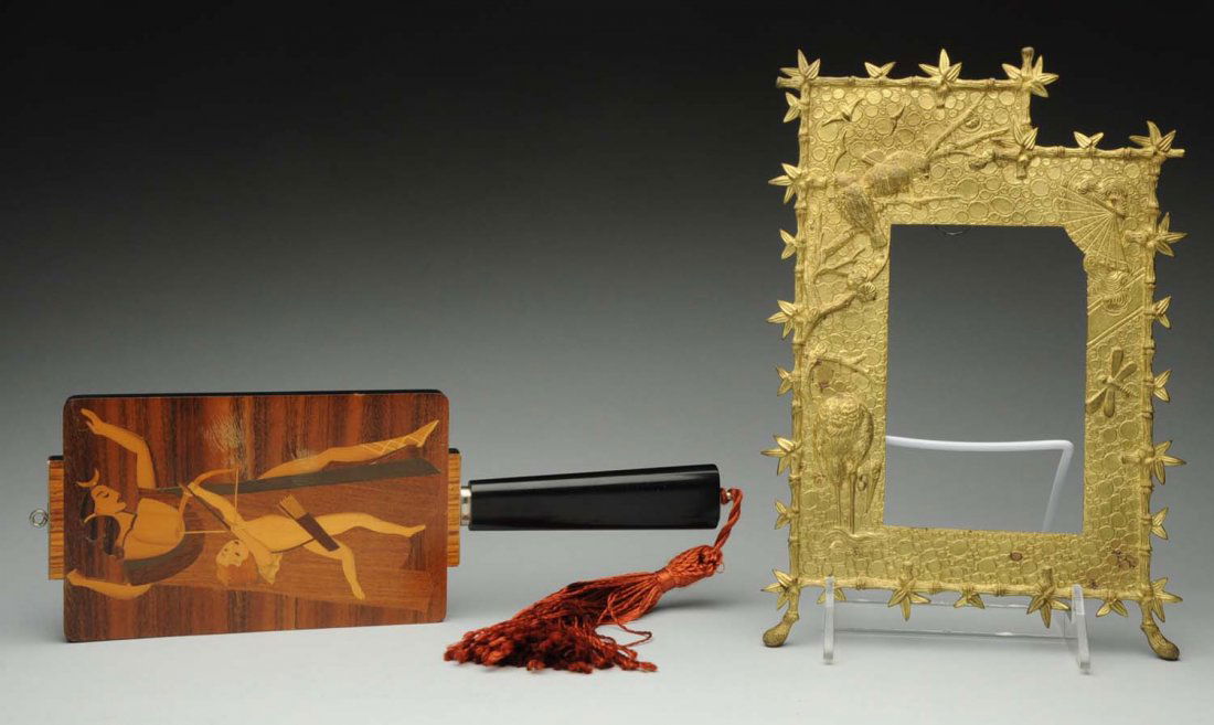 Lot of 2: Pieces.: One is an art deco hand mirror with inlaid wood depicting greek lady and child with bow and arrow. Second piece is an oriental brass picture frame depicting birds, crane and dragon fly. Size Largest: