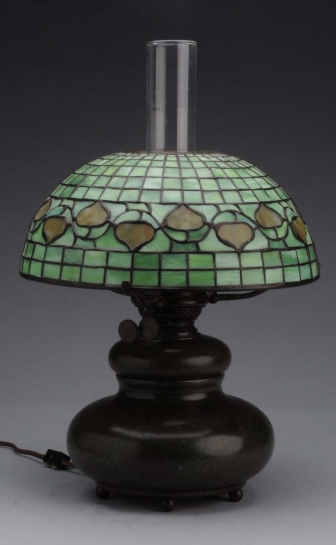 Tiffany Leaded Glass Lamp.: Reverse acorn pattern Signed "Tiffany Studios New York". On a signed Tiffany vase with kerosene holder. The shade is original, the base of questionable age. Condition (Excellent). Size 19 - 1/2" T. 12