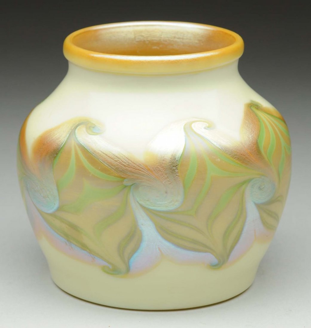 Tiffany Favrile Vase.: A favrile vase from the early Tiffany Corona Period with a pulled feather pattern in green and gold over a white colored back round. Beautiful gold iridescence over the double pulled feather decoratio
