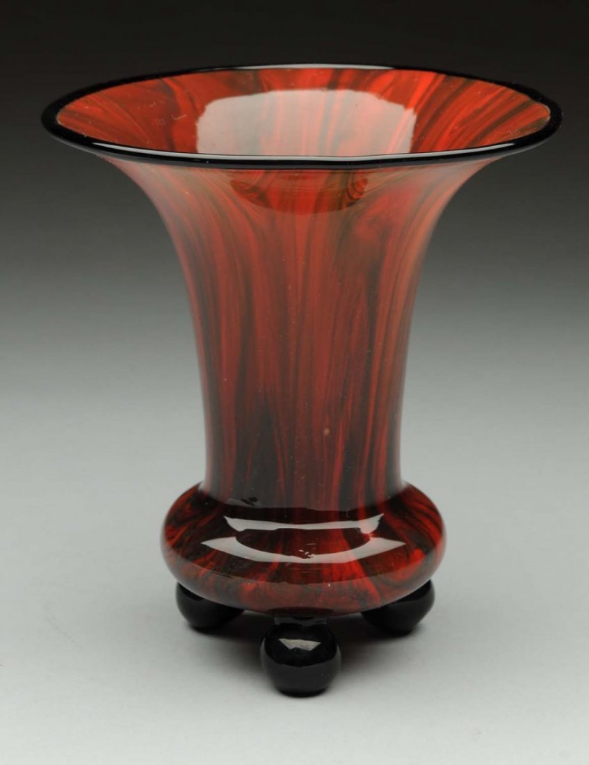 Loetz Phenomem Gre Vase with Ball Feet.: Loetz Phanomen Gre Vase in cased crystal over a variegated red and green pulled feather pattern with applied rim and three ball feet in black amethyst. Signed on base with the oval Czechoslovakia acid