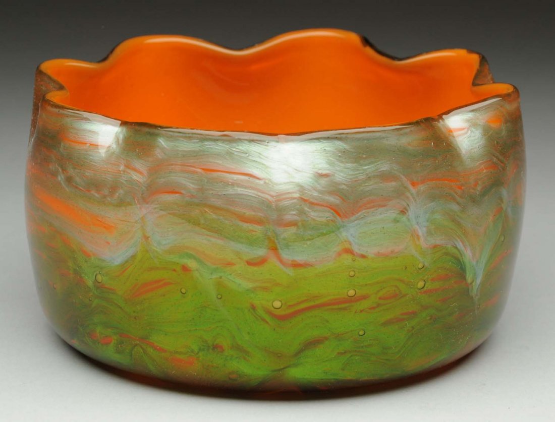 Loetz Titania Bowl.: Loetz Titania bowl, genre 2534 in orange opal with leaf green. Fine silvery pulled feather decoration over swirling orange and green cased with crystal. Condition (Excellent). Size 5 - 1/2" L.