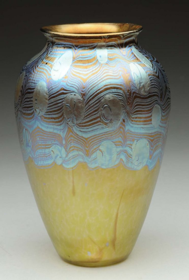 Loetz Argus Vase.: Early Loetz Phanomen vase in the Argus decor. Chestnut colored base glass with martele finish covered on the upper portion of the case with a silvery disc and pulled wave pattern covered in platinum b