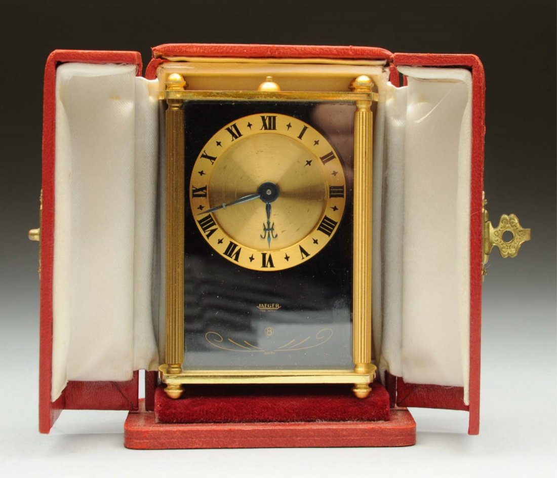 Jaeger Lecoultre 8 Day Musical Travel Clock.: Jaeger Lecoultre with day travel clock with music and alarm in fitted red leather case. Condition (Excellent). Size 3 - 3/4" T.