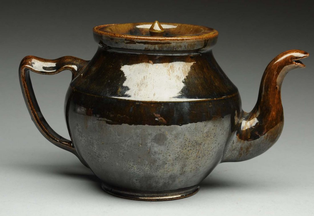 Signed George Ohr Tea Pot with Lid.: Signed "G.E. Ohr Biloxi, Miss." on bottom. Minor glaze loss to the inner rim where the lid is placed. Spout and handle intact. Condition (Excellent). Size 5 - 1/2" T.
