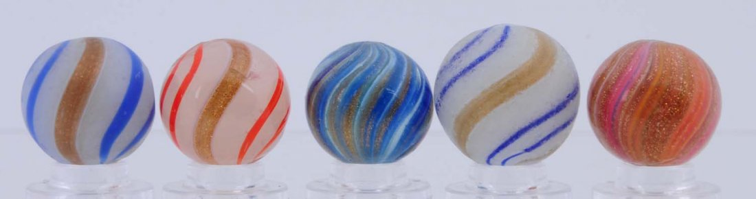 Lot of 5: Lutz Marbles.: Lot includes two white opaque lutz with blue bands, one semi opaque white base with red bands(this marble has a large reflection bruise.) The last two are multicolor onionskin lutz. Condition (8.0-8.7