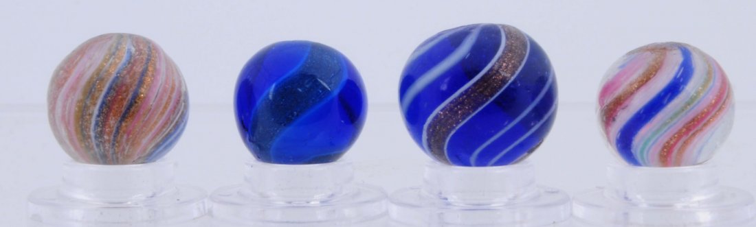 Lot of 4: Lutz Marbles.: The largest marble is blue transparent base with white bands, the smaller two red, blue and white onionskin Lutz and a blue glass white ribbon Lutz. Condition (8.6/9.2). Size 9/16" to 5/8" Dia.