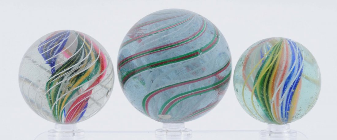 Lot of 3: Large Swirl Marble.: The two smaller are multicolor divided core and the largest is a white latticino core. This marble has two circular subsurface reflections. Condition (8.6 - 8.8). Size 1 - 3/4" to 2 - 11/32" Dia.