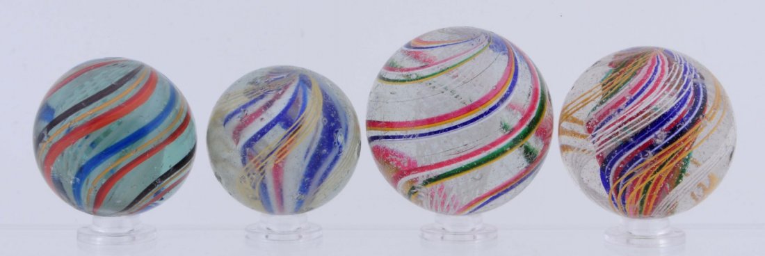 Lot of 4 : Large Swirl Marbles.: Lot includes two white latticino swirls and two multicolor divided core swirls. Condition (8.3 - 8.7). Size 1 - 15/32" to 1 - 13/16" Dia.