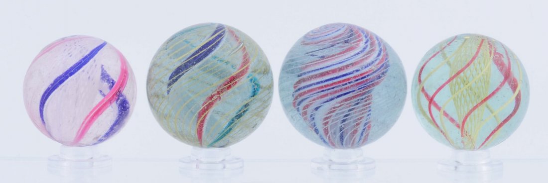 Lot of 4: Large Swirl Marbles.: Lot includes: yellow latticino end of cane, one white latticino , one red, white and blue solid core, and multicolor divided core swirl. Condition (8.6 - 8.9). Size 1 - 5/16" to 1 - 15/32" Dia.