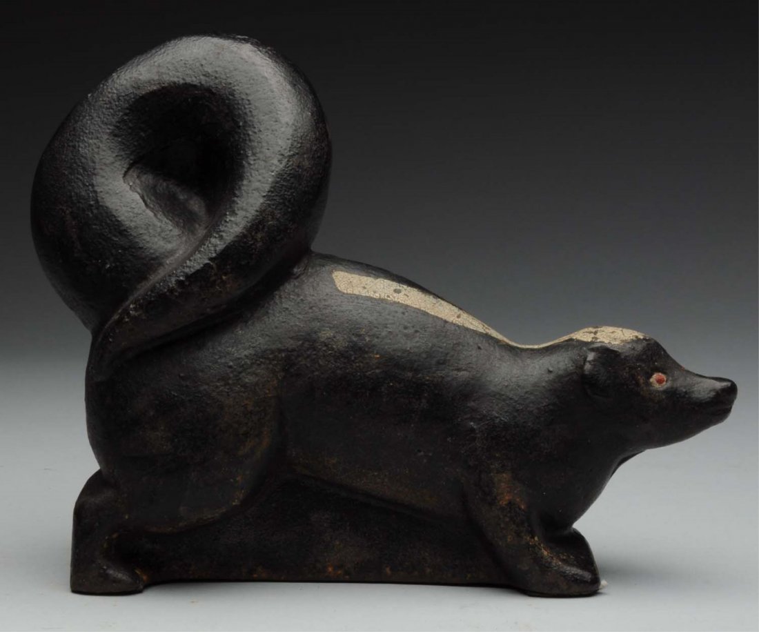 Cast Iron Skunk Doorstop.: Full-figure. Great pose of skunk with tail up over his back. Condition (Excellent). Size 6 - 3/8" T.