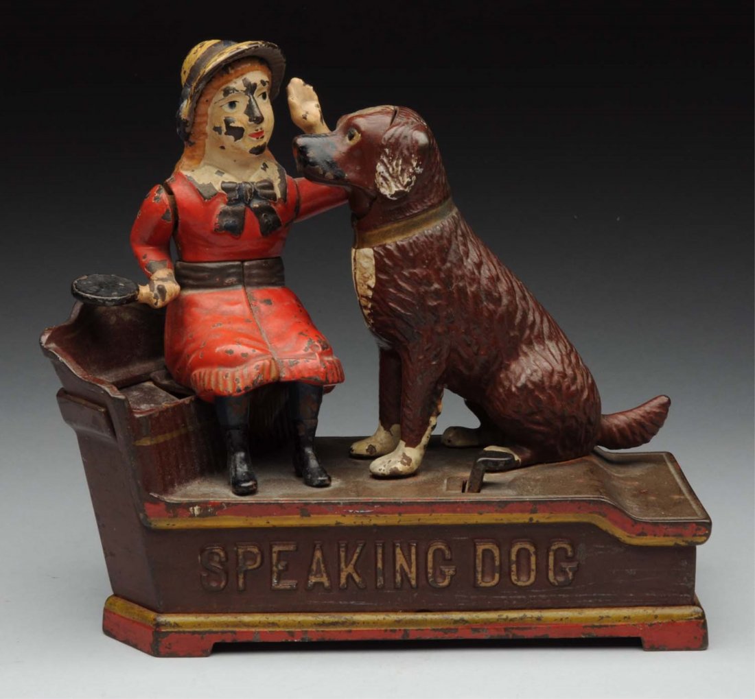 Cast Iron Speaking Dog Mechanical Bank.: Manufactured by Shepard Hardware Company. Red dress version. When in operation, figure drops penny in back trough. Embossed speaking dog on front. Nice highlights around the back. No cracks or breaks,