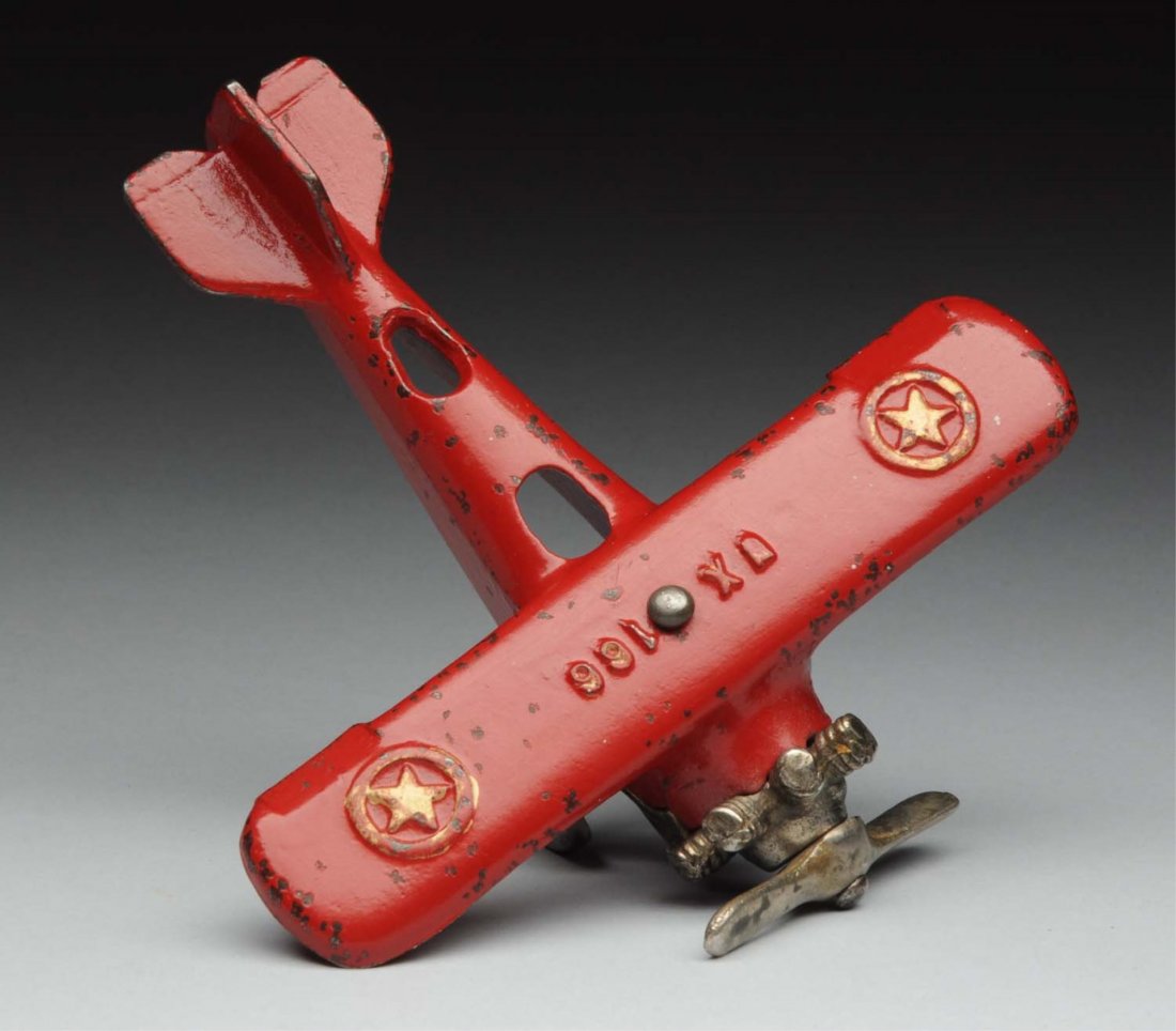 Cast Iron Kenton UX166 Toy Airplane.: Has nickel wheels and prop. Embossed UX166 on wing. Stars in circle mark on edge of each wing. Some chipping and wear throughout. Condition (Very Good - Excellent). Size 6" L.