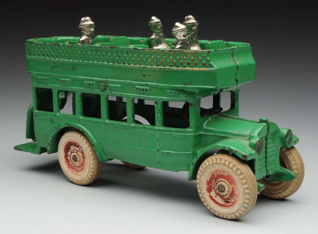 Cast Iron Arcade Double Decker Bus.: Earlier white rubber wheel version. Includes four nickel plated figures, and driver. Embossed "Arcade Freeport Ill" on bottom. Some general wear to wheels, especially to the painted hub caps. Some oth