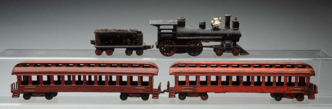 Cast Iron American Made Passenger Floor Train Set: Includes: steam type American bell with cow catcher replacement bell, matching eight wheel tender and two passenger cars. The passenger cars have been repainted. Some paint loss and wear throughout. C