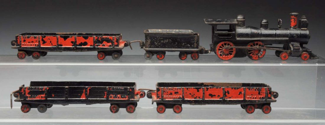 Cast Iron American Made Train Set.: Includes American style steam pipe engine with cow catcher matching 8eight wheel tender and three freight cars. Engine is missing bell. Red painted over back on cars. Is old repainting. Condition (Ver