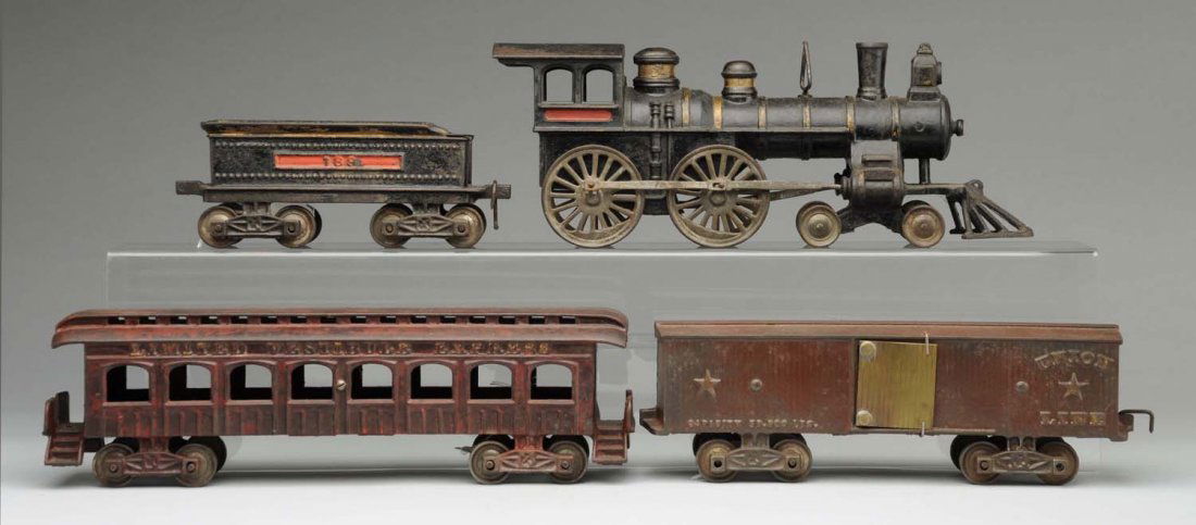 Cast Iron Ives Cannonball Freight Train Set.: American style steam-type engine with cow catcher. It is missing the original bell. Engine has matching eight-wheel tender, boxcar, and passenger car. Boxcar has "Union Line" embossed on both sides an