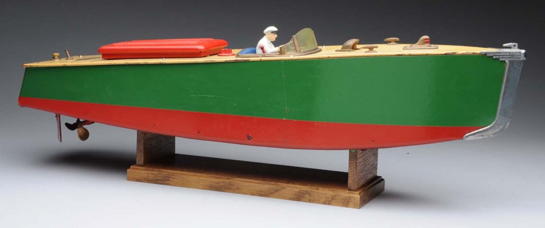 American made Orkin Craft Clockwork Motor Boat.: This beautiful speed boat with composition driver is operated by clockwork mechanism. Boat is made of wood and tin; has beautiful decal on back of boat that says "Orkin Craft Motor Boats". Includes ho