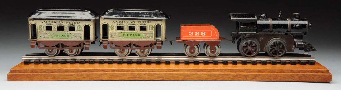 Flyer Pre-War O Gauge Chicago Passenger Train Set: This is an early American toy which includes a wind - up two band steam type engine with cast in cow catcher, a matching No. 328 tender, a four -wheel tender in red, and two scarce tri-colored Chicago