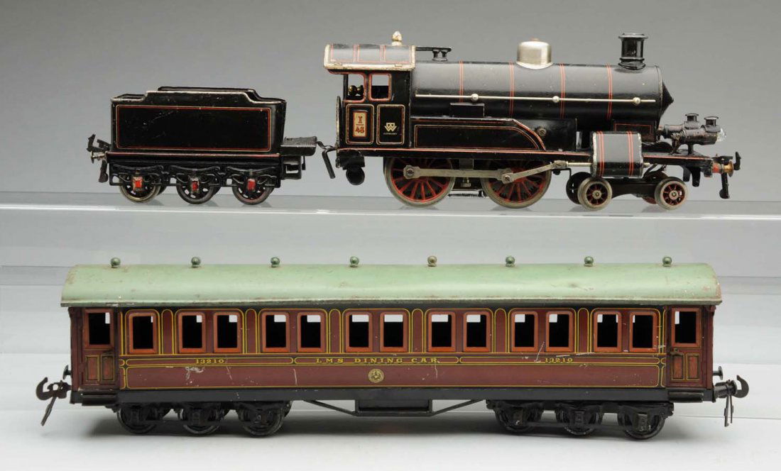 German Bing 1 Gauge Pre-War Passenger Train Set.: English-style engine which is electric. Steam-type engine with Bing mark on both sides of the cab. Also marked "I48." Comes with a matching six wheel tender, and one LMS dining car marked "13210." Not