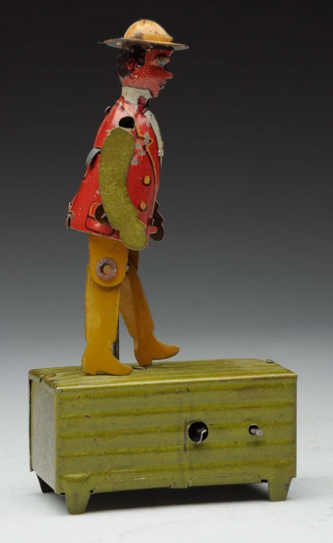 German African American Dancing Penny Toy.: Tin Litho. Crank operated. All original including arms. Very little wear. Condition (Excellent). Size 3 - 3/4" T.