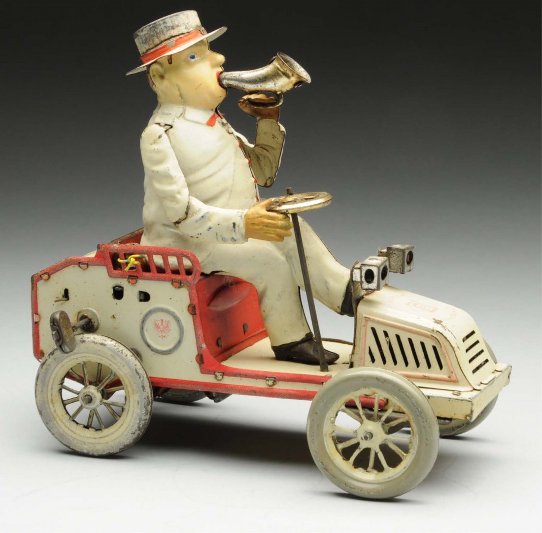 German Lehmann Tin Litho Wind-Up Tut-Tut Toy.: Marked "Lehmann Tut-Tut" on rear of toy. Lehmann bell mark on front hood, with original horn and front headlights. Bellow is present, but no longer emitting any noise. General overall fading and wear 