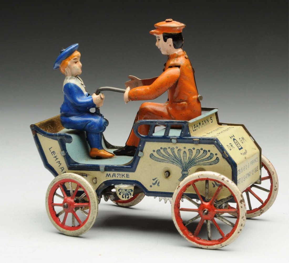 Lehmann Tin Litho Wind-Up Naughty Boy Toy.: German. Toy depicts man and boy riding in automobile. Marked "Patent 1903 Made in Germany". There is some scratching and wear throughout, especially to wheels. Condition (Very Good). Size 5" L.