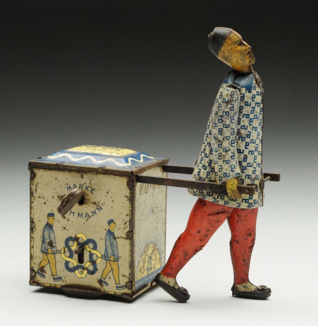 Lehmann Tin Litho Wind-Up Nu-Nu Toy.: German. Toy depicts a Chinese man pulling a cart. Man is missing ponytail. Marked "Made in Germany" on back. Man has original arms. They toy has moderate to heavy scratching and wear throughout. Condi