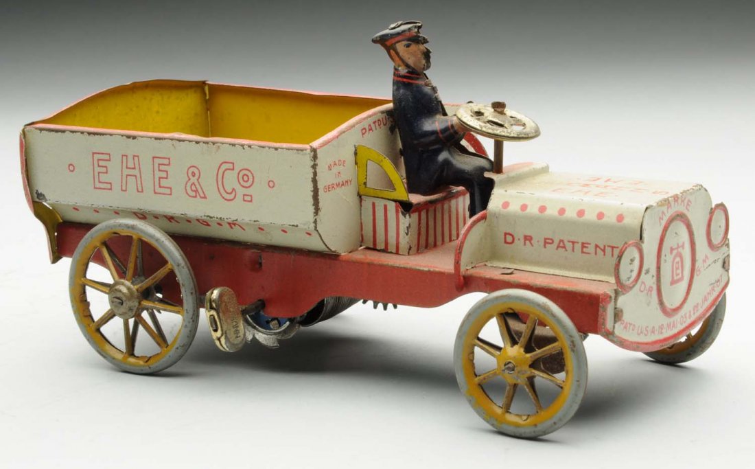 Lehmann Tin Litho Wind-Up Ehe & Co. Toy Truck.: German. Toy includes original lithograph driver. Truck is marked "Ehe & Co." on sides and "Lehmann" on back. There is some fading and edge wear. Condition (Very Good). Size 6 - 3/4" L.