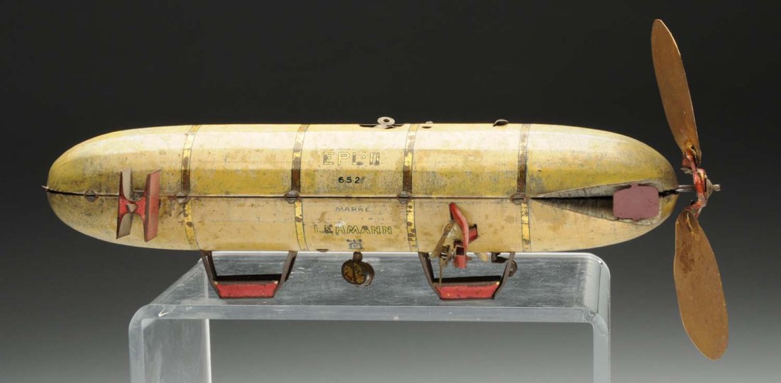 Lehmann Tin Litho Wind-Up Zeppelin Toy.: German. Toy is marked "EPL II" and has replacement back celluloid fins that have been painted. Zeppelin shows moderate to heavy rubbing and wear. Condition (Good). Size 10" L.