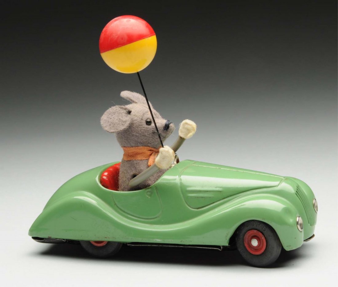 Schuco Tin Litho Wind-Up Sonny Mouse in Car Toy.: Marked "2005 Sonny" on bottom, and "Made in US Zone, Germany". When in operation, mouse's arms go up and right hand holds plastic balloon. There is some scratching and wear to car. Condition (Very Goo