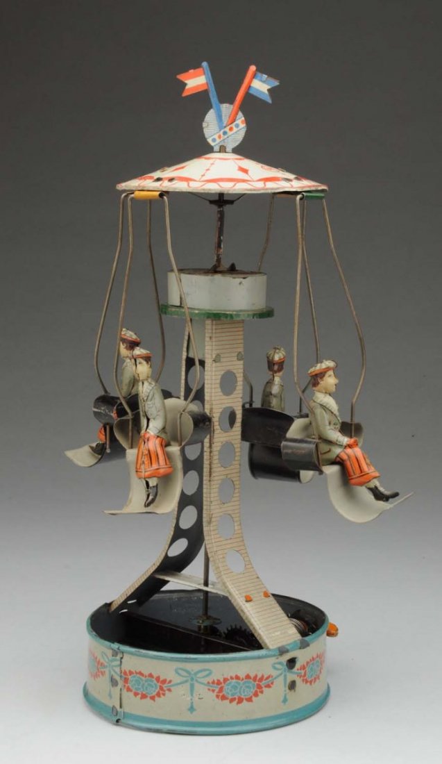 German Tin Litho Wind-Up Go-Around Toy.: Marked "WK" and "Made in Germany" on top. Original duel flag on top. Four Lithograph men in carts that spin around when toy is being operated. Very nice lithography. Some general edge wear. Condition 