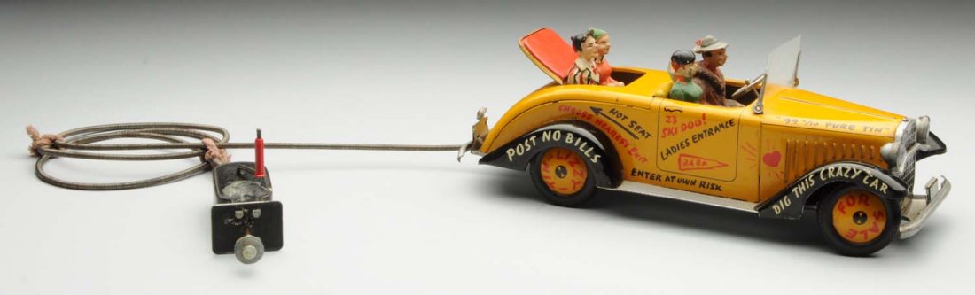 Arnold Tin Litho Tin Lizzy Automobile.: German. Plunger activated with cord. Plunger is no longer working. The toy has original composition figures, writing all over automobile, and very little wear. Condition (Excellent). Size 9 - 1/2" L.
