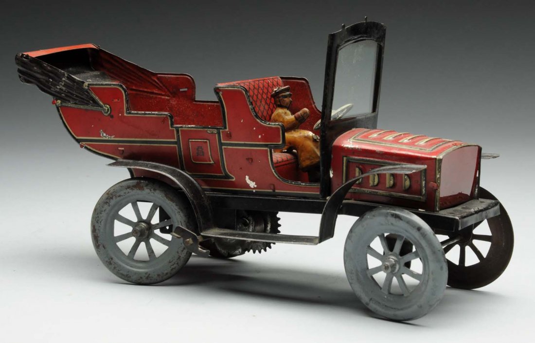 German Tin Litho Wind-Up Open Touring Car.: Includes original driver. Mechanism not working. Stamped "Germany" on bottom of car. Original windshield with beveled glass. Some wear to wheels. Condition (Very Good - Excellent). Size 9" L.