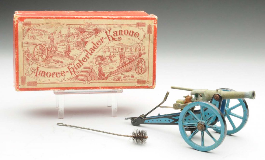 Early German Hand Painted Marklin Cannon Toy.: Includes original box and brush. Box marked "Amorce-Hinferlader-Kanone." Cannon is in the usual Marklin blue. Has early Marklin shield on top of cannon. Missing circular breech loader. Otherwise some 