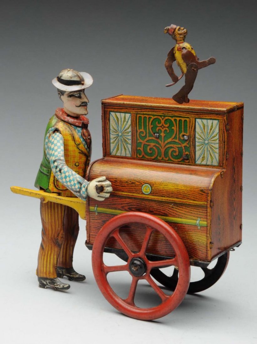 German Distler Pete &The Monk Organ Grinder Toy.: This tin litho wind - up toy is a beautifully lithographed toy. Depicts man cranking organ grinder which has plink plink noise and monkey dancing on top ledge, extremely difficult to find complete wit