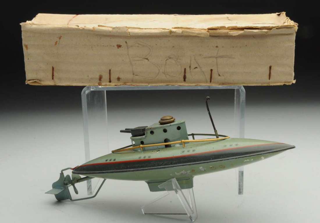 Bing Clockwork Submarine Toy.: German. Pre-war. Hand painted with original screw cap. Comes in what appears to be the original box, which has markings "Made in Germany". There is some litho loss to the upper side of the submarine n