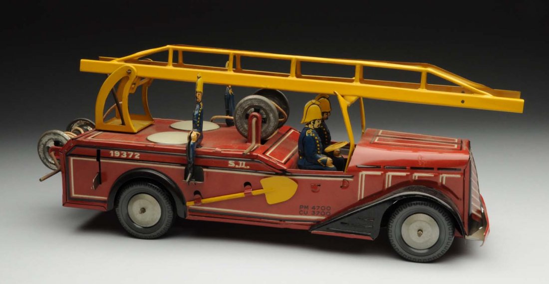 French Tin Litho Fireman Ladder Truck.: Marked "Joustra" on bottom. Toy includes original ladders. There is some bending to the windshield. Has four tin litho firemen and two tin litho shovel on sides of truck. Condition (Very Good - Excell