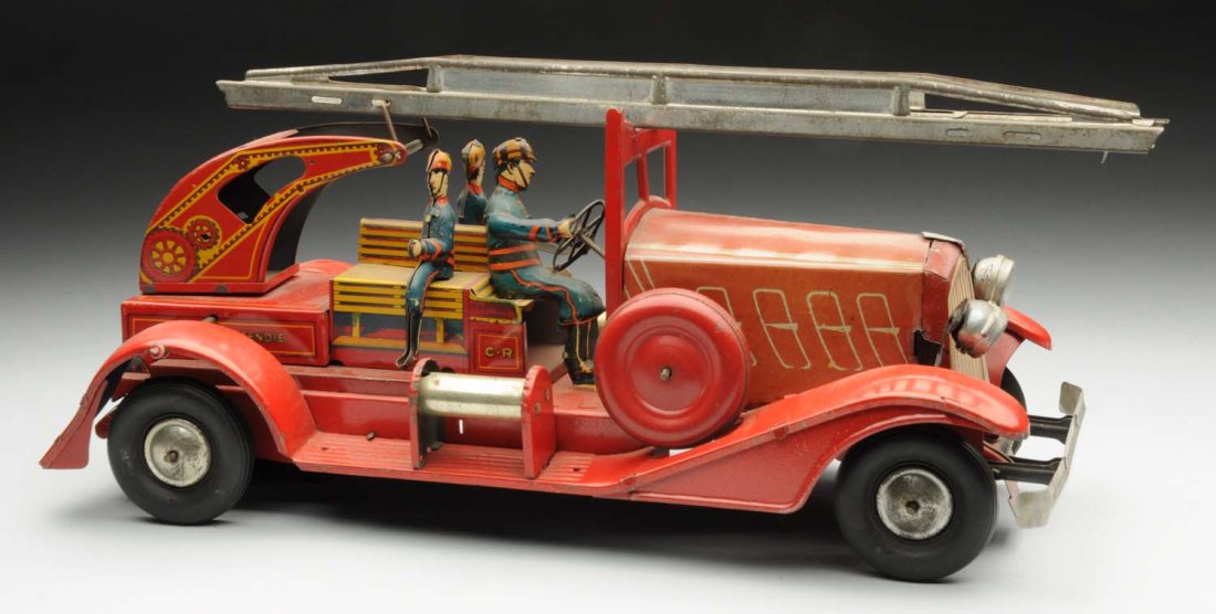 French Tin Litho Wind-Up Fire Engine Toy.: Marked "C.R." on sides. Toy has three tin litho firemen, rubber tires, original headlights, and extension ladder on top. There is some general scratching and wear, mostly to fenders. Condition (Very G
