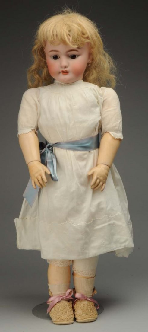 Pert S & C Child Doll.: German bisque socket head incised “S & C Germany 15” by Franz Schmidt & Co., with multi-stroked eyebrows, sleeping eyes with painted lashes, open mouth with upper teeth, pierced ears (tiny flake o