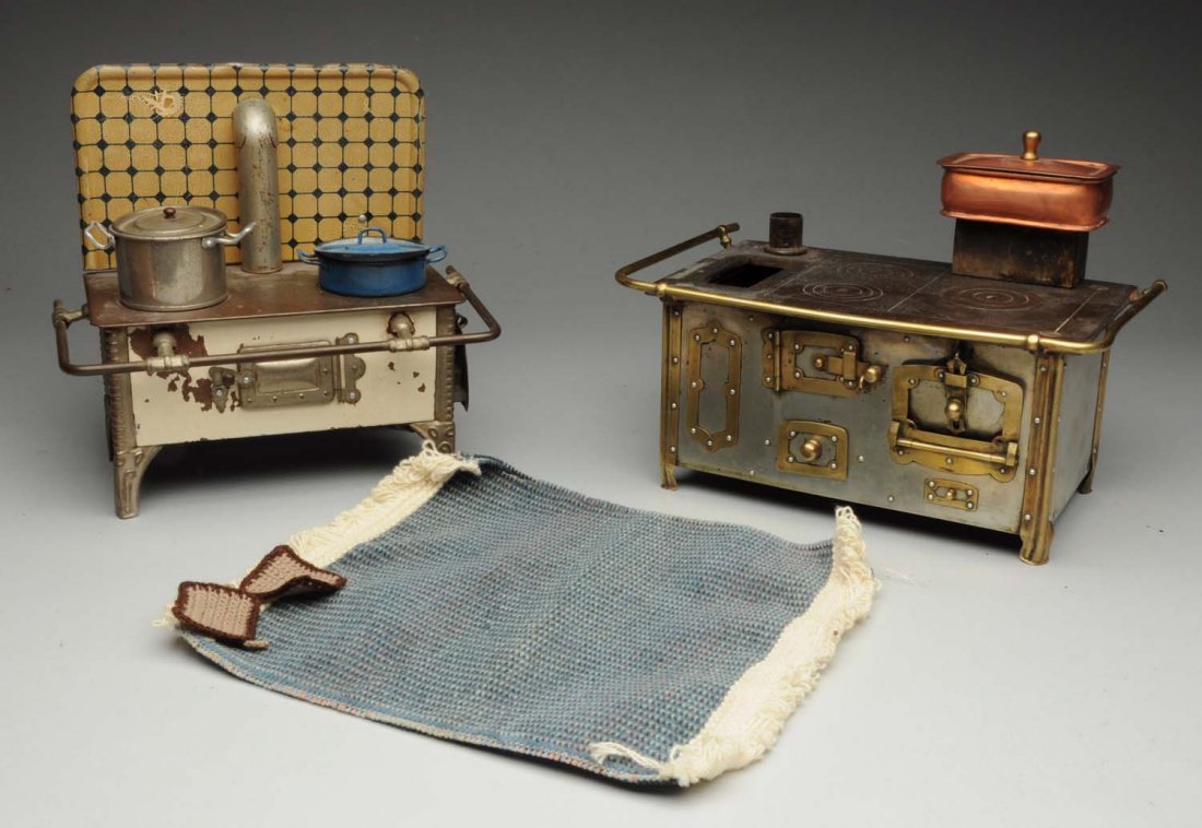 Lot of 2: Toy Stoves and Accessories.: This lot includes a brass and steel stove and a tin stove. Both have some accessories. Condition (Very Good Plus).