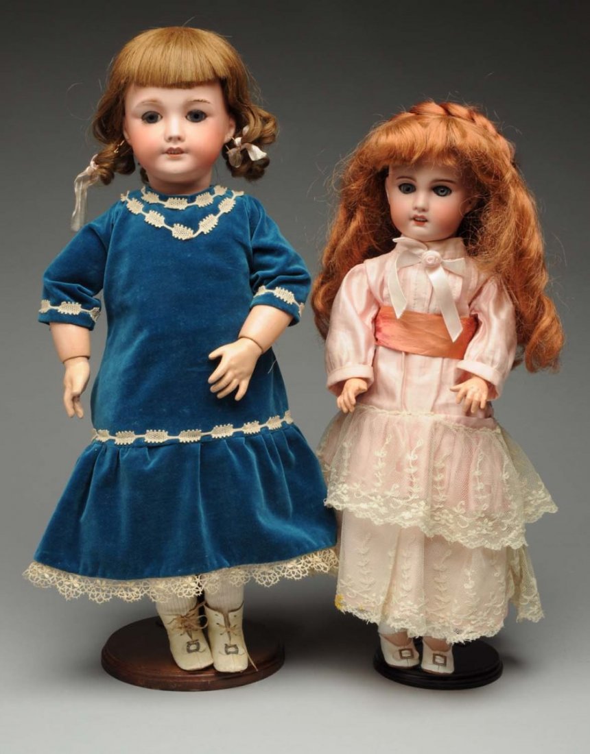 Lot of 2: SFBJ Child Dolls.: French bisque socket heads with sleeping eyes, multi-stroked eyebrows, open mouths, pierced ears. One incised “SFBJ Paris” from the Jumeau mold with original human hair wig, composition and wood b
