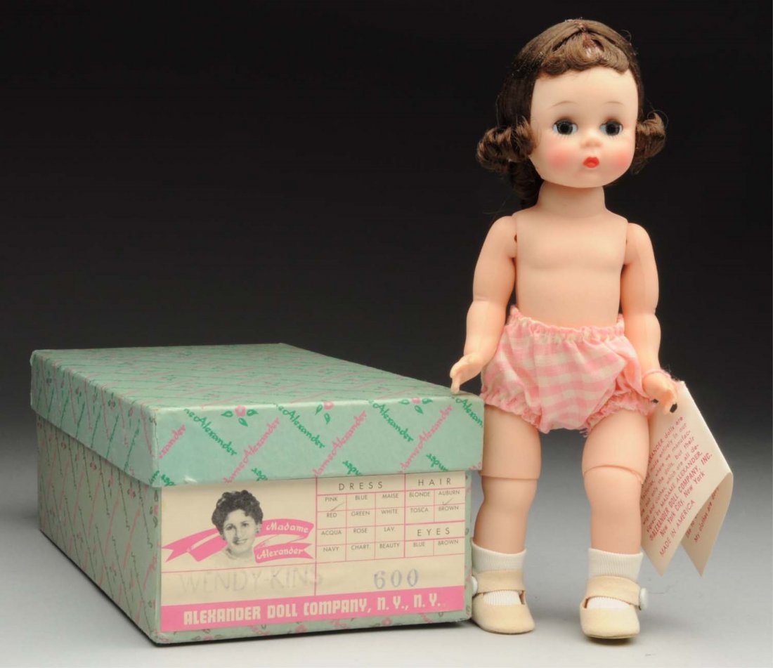 Madame Alexander “Wendy.”: Hard plastic bent-knee walker with dark hair, pink checked panties, wrist tag, in original box with “Wendy-Kins 600” label. Beautiful bright color! Condition (Excellent). Size 8" T.