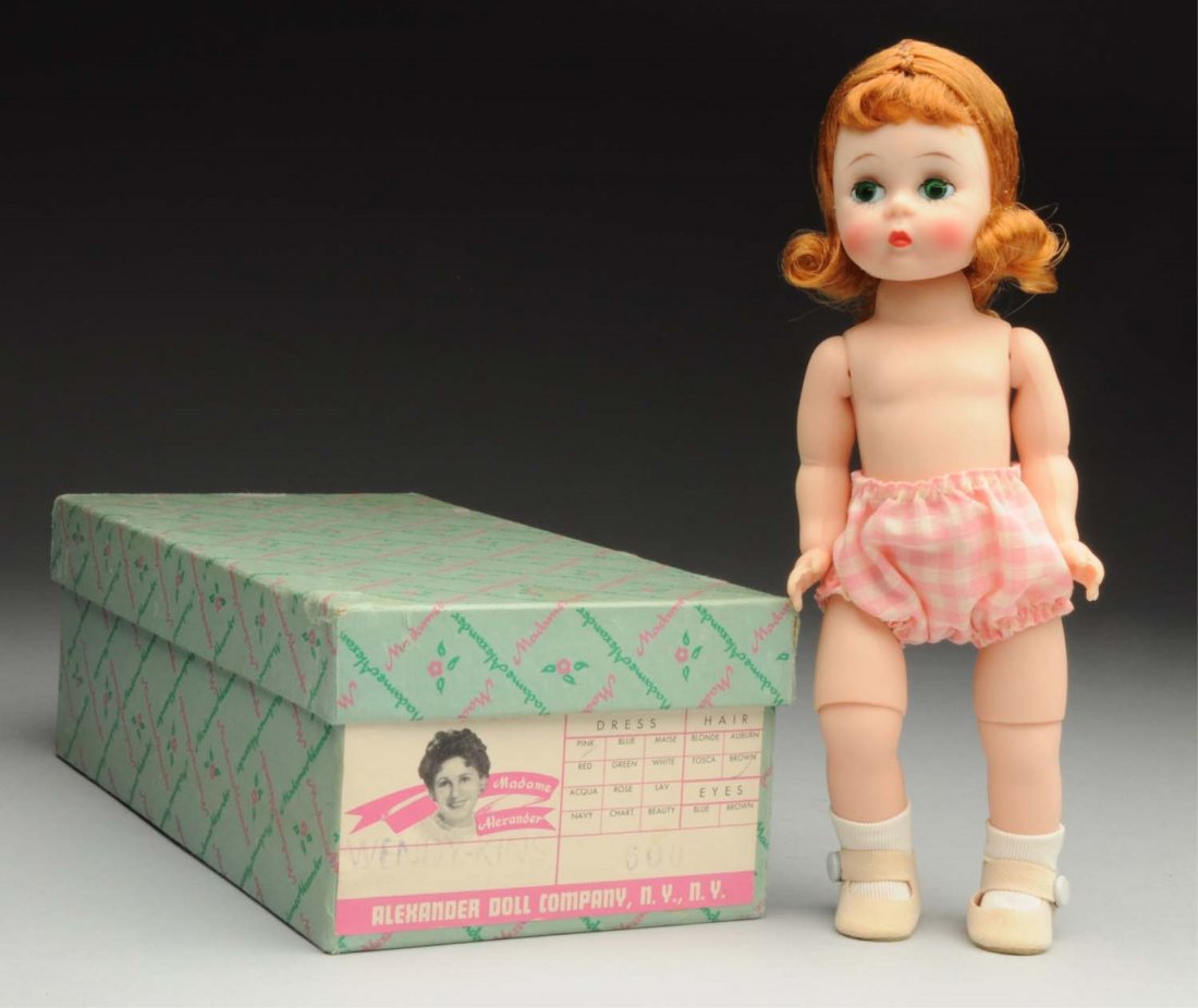 Madame Alexander “Wendy.”: Hard plastic bent-knee walker with reddish hair, pink checked panties, wrist tag, in original box with “Wendy-Kins 600” label. Beautiful bright color! Condition (Excellent). Size 8" T.